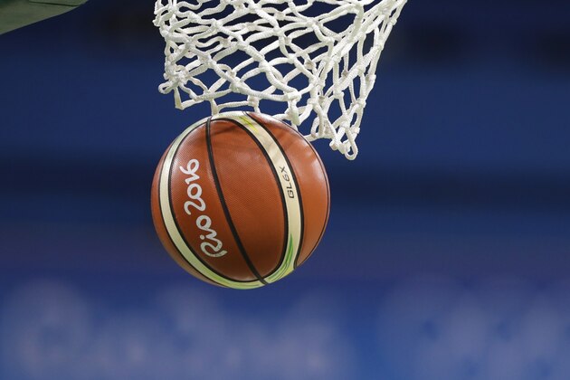 A FIBA Rio 2016 basketball goes through the net during the first half of a women's basketball game between Spain and Serbia at the Youth Center at the 2016 Summer Olympics in Rio de Janeiro, Brazil, Sunday, Aug. 7, 2016. (AP Photo/Carlos Osorio)