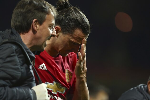 Manchester United's Zlatan Ibrahimovic leaves the field with an injury during the Europa League quarterfinal second leg soccer match between Manchester United and Anderlecht at Old Trafford stadium, in Manchester, England, Thursday, April 20, 2017. (AP Photo/Dave Thompson)