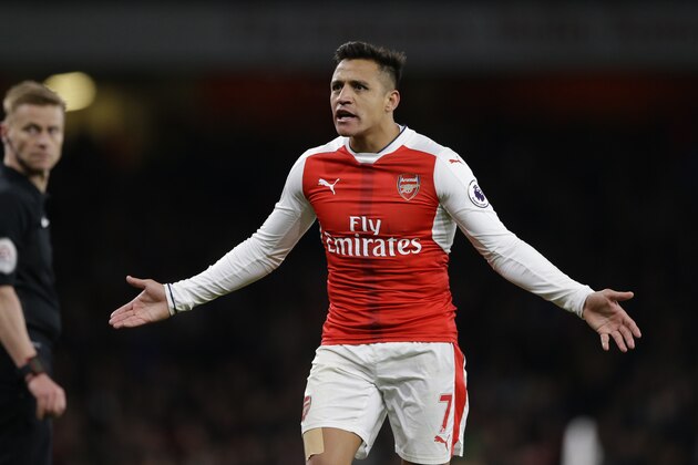 Arsenal's Alexis Sanchez reacts and looks at the assistant referee after being shown a yellow card by referee Mike Jones, during the English Premier League soccer match between Arsenal and Leicester City at the Emirates Stadium in London, Wednesday, April 26, 2017. (AP Photo/Alastair Grant)