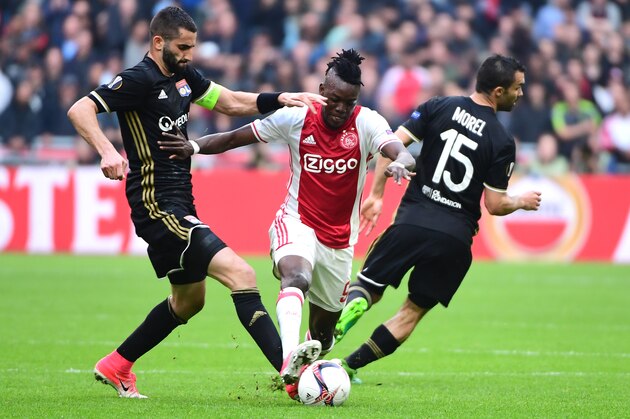 Lyon's French midfielder Maxime Gonalons (L) and Lyon's French defender Jeremy Morel (R) vie with Ajax forward Bertrand Traoré (C) during UEFA Europa League semi-final, first leg, Ajax Amsterdam v Olympique Lyonnais (OM) on May 3, 2017 in Amsterdam.  / AFP PHOTO / Emmanuel DUNAND        (Photo credit should read EMMANUEL DUNAND/AFP/Getty Images)
