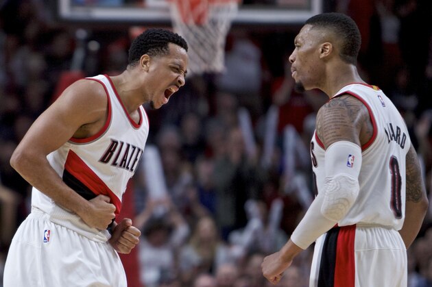 Portland Trail Blazers guard CJ McCollum, left, and guard Damian Lillard react after McCollum scored late in the second half of an NBA basketball game against the Milwaukee Bucks in Portland, Ore., Tuesday, March 21, 2017. The Bucks won 93-90. (AP Photo/Craig Mitchelldyer)