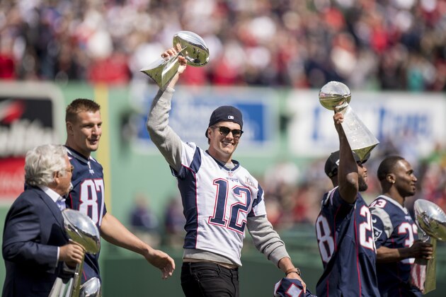 BOSTON, MA - APRIL 3: Tom Brady #12 of the New England Patriots holds the Super Bowl trophy alongside Owner Robert Kraft, Rob Gronkowski #87, James White #28, and Dion Lewis #33 during a pre-game ceremony before the Boston Red Sox home opener against the Pittsburgh Pirates on April 3, 2017 at Fenway Park in Boston, Massachusetts. (Photo by Billie Weiss/Boston Red Sox/Getty Images)