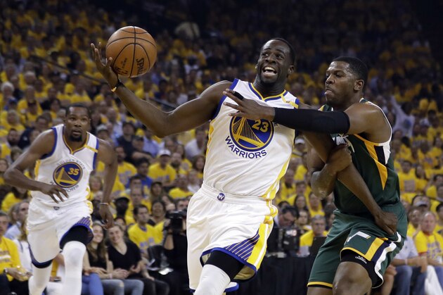 Golden State Warriors forward Draymond Green (23) is fouled by Utah Jazz forward Joe Johnson, right, during the first half in Game 1 of an NBA basketball second-round playoff series, Tuesday, May 2, 2017, in Oakland, Calif. (AP Photo/Marcio Jose Sanchez)