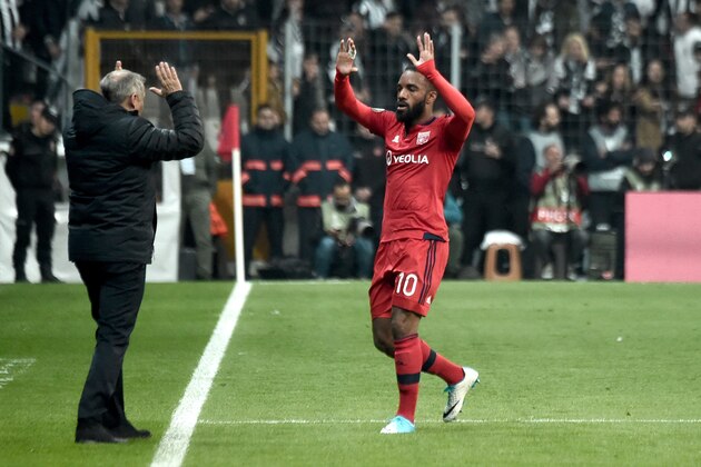 Lyon's Alexandre Lacazette (R) celebrates with head coach Bruno Genesio (L) during the UEFA Europa League second leg quarter final football match between Besiktas and Lyon (OL) on April 20, 2017, at the Vodafone arena stadium in Istanbul. / AFP PHOTO / OZAN KOSE        (Photo credit should read OZAN KOSE/AFP/Getty Images)
