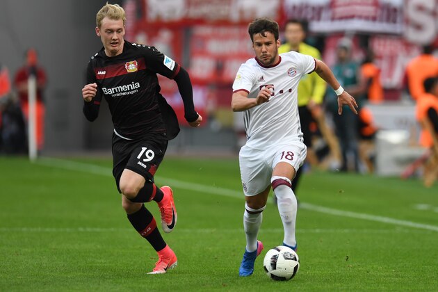 Leverkusen's midfielder Julian Brandt (L) and Bayern Munich's Spanish defender Juan Bernat vie for the ball during the German First division Bundesliga football match between Bayer 04 Leverkusen and FC Bayern Munich in Leverkusen, on April 15, 2017. / AFP PHOTO / PATRIK STOLLARZ / RESTRICTIONS: DURING MATCH TIME: DFL RULES TO LIMIT THE ONLINE USAGE TO 15 PICTURES PER MATCH AND FORBID IMAGE SEQUENCES TO SIMULATE VIDEO. == RESTRICTED TO EDITORIAL USE == FOR FURTHER QUERIES PLEASE CONTACT DFL DIRECTLY AT + 49 69 650050
        (Photo credit should read PATRIK STOLLARZ/AFP/Getty Images)