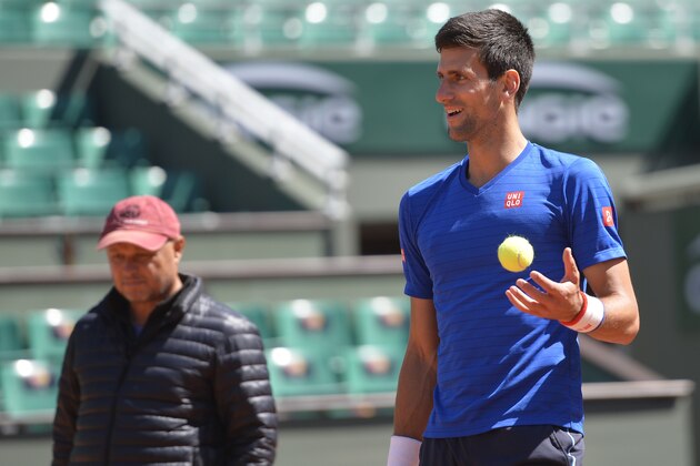Novak Djokovic of Serbia and his coach Marian Vajda (L) attend a training session prior the 2015 French Open tennis championships at the Roland Garros stadium in Paris on May 20, 2015. AFP PHOTO / MIGUEL MEDINA        (Photo credit should read MIGUEL MEDINA/AFP/Getty Images)