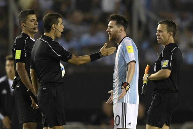 Argentina's forward Lionel Messi (2nd-R) argues with second assistant referee Marcelo Vangasse (2nd-L) next to Brazilian referee Sandro Ricci (L) and first assistant referee Emerson Augusto de Carvalho (R)during the half time of their 2018 FIFA World Cup Russia South American qualifier football match against Chile, at the Monumental stadium in Buenos Aires, on March 23, 2017. 
The FIFA on March 28, 2017 suspended Messi for four Argentina games. / AFP PHOTO / JUAN MABROMATA        (Photo credit should read JUAN MABROMATA/AFP/Getty Images)