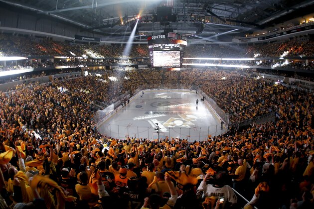 The crowd waves towels and cheers as lasers and spotlights swirl over the ice at Consol Energy Center before Game 5 of the NHL hockey Stanley Cup Eastern Conference finals between the Pittsburgh Penguins and the Tampa Bay Lightning, Sunday, May 22, 2016, in Pittsburgh. (AP Photo/Gene J. Puskar)