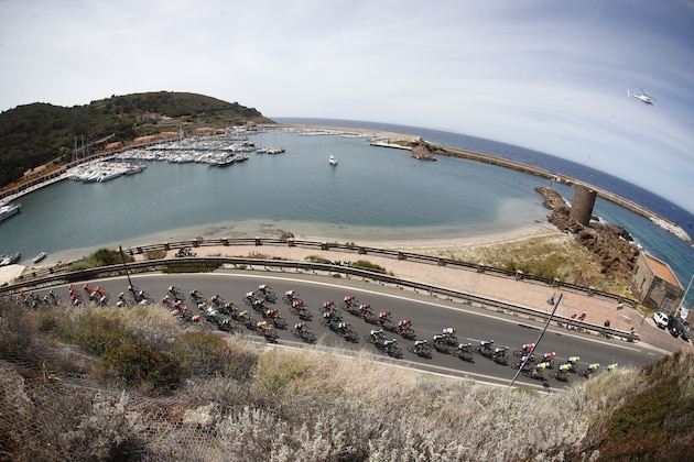 The peloton rides in Castelsardo al Porto during the first stage of the 100th Giro d'Italia cycling race, Tour of Italy, from Alghero to Olbia on May 5, 2017 in Sardinia.  / AFP PHOTO / Luk BENIES        (Photo credit should read LUK BENIES/AFP/Getty Images)