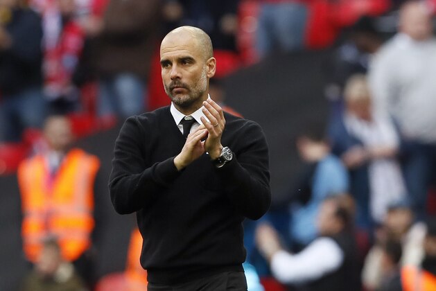 Manchester City manager Pep Guardiola applauds at the end of the English FA Cup semifinal soccer match between Arsenal and Manchester City at Wembley stadium in London, Sunday, April 23, 2017. Arsenal won 2-1. (AP Photo/Kirsty Wigglesworth)