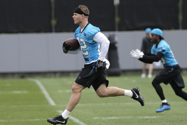 Carolina Panthers' Christian McCaffrey (22) runs a drill during the NFL football team's rookie camp in Charlotte, N.C., Friday, May 5, 2017. The Panthers hope that McCaffrey's being raise in an NFL family, his father was a three-time Super Bowl champion, will help make the transition from college that much easier. (AP Photo/Chuck Burton)