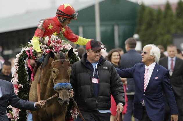 Mike Smith celebrates with trainer Bob Baffert after riding Abel Tasman to victory in the 143rd running of the Kentucky Oaks horse race at Churchill Downs Friday, May 5, 2017, in Louisville, Ky. (AP Photo/David J. Phillip)