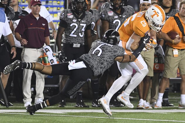 BRISTOL, TN - SEPTEMBER 10: Wide receiver Josh Smith #25 of the Tennessee Volunteers breaks the attempted tackle by safety Mook Reynolds #6 of the Virginia Tech Hokies in the second half at Bristol Motor Speedway on September 10, 2016 in Bristol, Tennessee. Tennessee defeated Virginia Tech 45-24. (Photo by Michael Shroyer/Getty Images)