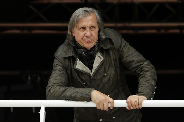 FILE - In this Monday, May 23, 2016 file picture, former Romanian tennis ace Ilie Nastase watches a match of the French Open tennis tournament at the Roland Garros stadium, in Paris, France. Ilie Nastase has received Romania's highest award, the Star of Romania, on his 70th birthday from President Klaus Iohannis for services to sport in Bucharest, Romania, Tuesday, July 19, 2016. (AP Photo/Alastair Grant, File)