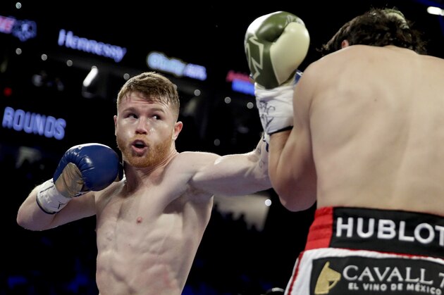Canelo Alvarez, left, of Mexico, fights Julio Cesar Chavez Jr., of Mexico, during their catch weight boxing match, Saturday, May 6, 2017, in Las Vegas. (AP Photo/John Locher)