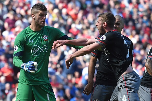 Southampton's English defender Jack Stephens (R) congratulates Southampton's English goalkeeper Fraser Forster after he saved a penalty during the English Premier League football match between Liverpool and Southampton at Anfield in Liverpool, north west England on May 7, 2017. / AFP PHOTO / PAUL ELLIS / RESTRICTED TO EDITORIAL USE. No use with unauthorized audio, video, data, fixture lists, club/league logos or 'live' services. Online in-match use limited to 75 images, no video emulation. No use in betting, games or single club/league/player publications.  /         (Photo credit should read PAUL ELLIS/AFP/Getty Images)
