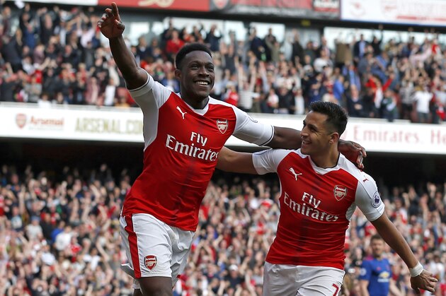 Arsenal's English striker Danny Welbeck (L) celebrates with Arsenal's Chilean striker Alexis Sanchez after scoring their second goal of the English Premier League football match between Arsenal and Manchester United at the Emirates Stadium in London on May 7, 2017.  / AFP PHOTO / IKIMAGES / Ian KINGTON / RESTRICTED TO EDITORIAL USE. No use with unauthorized audio, video, data, fixture lists, club/league logos or 'live' services. Online in-match use limited to 45 images, no video emulation. No use in betting, games or single club/league/player publications.  /         (Photo credit should read IAN KINGTON/AFP/Getty Images)