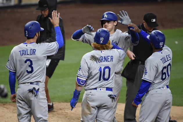 SAN DIEGO, CA - MAY 6: Cody Bellinger #35 of the Los Angeles Dodgers, is congratulated by Chris Taylor #3, Justin Turner #10, and Andrew Toles #60 after hitting a grand slam during the ninth inning of a baseball game against the San Diego Padres at PETCO Park on May 6, 2017 in San Diego, California.  (Photo by Denis Poroy/Getty Images)