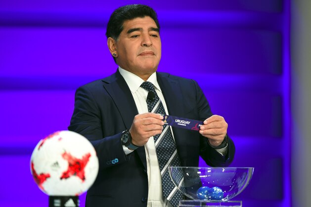 Argentinian football star Diego Maradona holds up the name of Uruguay during the official draw for the FIFA under-20 football World Cup in Suwon, south of Seoul, on March 15, 2017.
The FIFA U-20 World Cup will be held in South Korea from May 20 to June 11. / AFP PHOTO / JUNG Yeon-Je        (Photo credit should read JUNG YEON-JE/AFP/Getty Images)