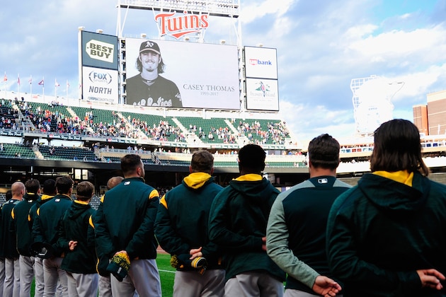MINNEAPOLIS, MN - MAY 02: The Oakland Athletics stand for a moment of silence for minor league player Casey Thomas, who died suddenly today, before a game against the Minnesota Twins on May 2, 2017 at Target Field in Minneapolis, Minnesota. (Photo by Hannah Foslien/Getty Images)