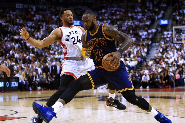 TORONTO, ON - MAY 05:  Lebron James #23 of the Cleveland Cavaliers dribbles the ball as Norman Powell #24 of the Toronto Raptors defends in the second half of Game Three of the Eastern Conference Semifinals during the 2017 NBA Playoffs at Air Canada Centre on May 5, 2017 in Toronto, Canada.  NOTE TO USER: User expressly acknowledges and agrees that, by downloading and or using this photograph, User is consenting to the terms and conditions of the Getty Images License Agreement.  (Photo by Vaughn Ridley/Getty Images)