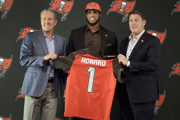 CORRECTS SPELLING OF LAST NAME TO KOETTER, NOT COTTER  - Tampa Bay Buccaneers 2017 first round draft pick O.J. Howard, center, holds a jersey as he poses with head coach Dirk Koetter, left, and general manager Jason Licht during an NFL football news conference Friday, April 28, 2017, in Tampa, Fla. Howard was a tight end at Alabama. (AP Photo/Chris O'Meara)