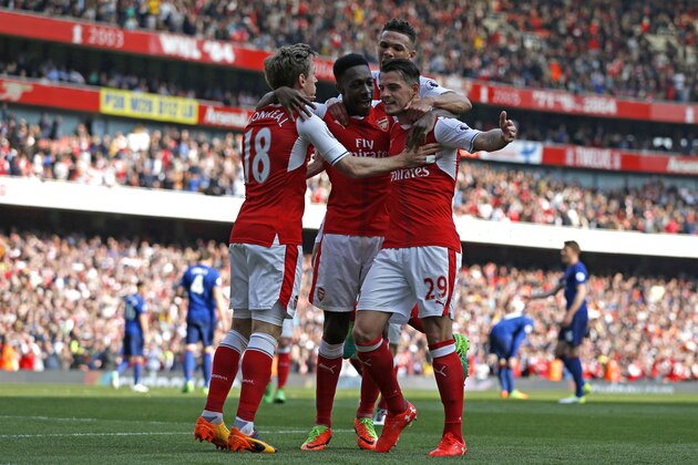 Arsenal's Swiss midfielder Granit Xhaka celebrates with (L-R) Arsenal's Spanish defender Nacho Monreal, Arsenal's English striker Danny Welbeck and Arsenal's English defender Kieran Gibbs after scoring the opening goal of the English Premier League football match between Arsenal and Manchester United at the Emirates Stadium in London on May 7, 2017.  / AFP PHOTO / IKIMAGES / Ian KINGTON / RESTRICTED TO EDITORIAL USE. No use with unauthorized audio, video, data, fixture lists, club/league logos or 'live' services. Online in-match use limited to 45 images, no video emulation. No use in betting, games or single club/league/player publications.  /         (Photo credit should read IAN KINGTON/AFP/Getty Images)