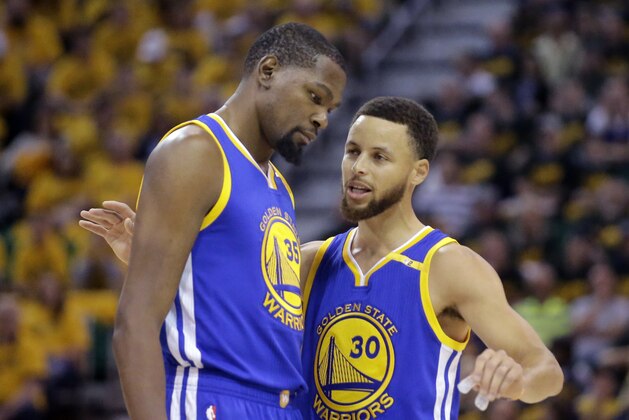 Golden State Warriors' Stephen Curry (30) and Kevin Durant (35) talk in the first half during Game 3 of the NBA basketball second-round playoff series against the Utah Jazz, Saturday, May 6, 2017, in Salt Lake City. (AP Photo/Rick Bowmer)