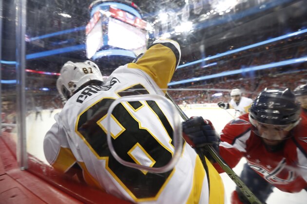 Pittsburgh Penguins center Sidney Crosby (87) is checked into the boards by Washington Capitals defenseman Matt Niskanen (2) during the first period of Game 5 in the second-round of the NHL hockey Stanley Cup playoffs, Saturday, May 6, 2017, in Washington. The Capitals won 4-2. (AP Photo/Carolyn Kaster)