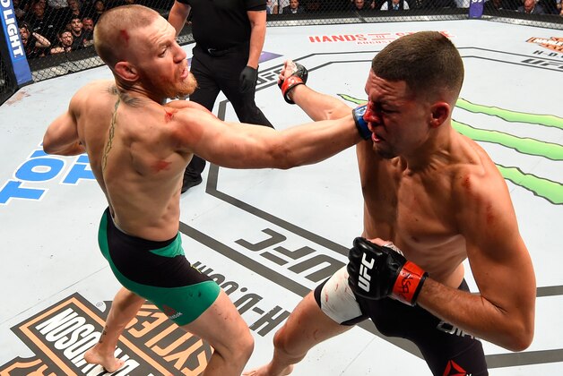 LAS VEGAS, NV - AUGUST 20:   (L-R) Conor McGregor of Ireland punches Nate Diaz in their welterweight bout during the UFC 202 event at T-Mobile Arena on August 20, 2016 in Las Vegas, Nevada. (Photo by Josh Hedges/Zuffa LLC/Zuffa LLC via Getty Images)