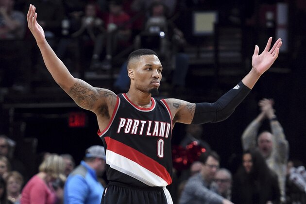 Portland Trail Blazers guard Damian Lillard acknowledges the crowd during the second half of the team's NBA basketball game against the Utah Jazz in Portland, Ore., Saturday, April 8, 2017. Lillard scored a franchise-record 59 points as the Blazers won 101-86. (AP Photo/Steve Dykes)
