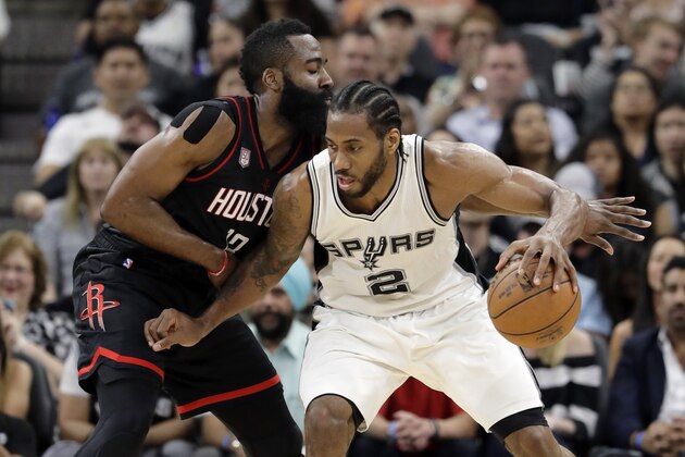 San Antonio Spurs forward Kawhi Leonard (2) works for an opportunity to the basket as Houston Rockets' James Harden, left, defends during the first half of Game 2 in a second-round NBA basketball playoff series, Wednesday, May 3, 2017, in San Antonio. (AP Photo/Eric Gay)