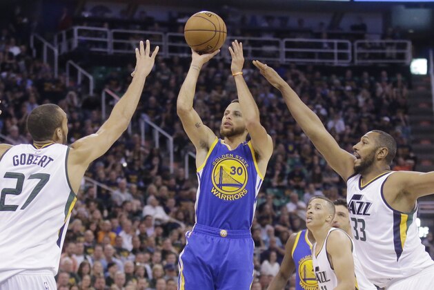 Golden State Warriors guard Stephen Curry (30) shoots as Utah Jazz's Rudy Gobert (27) and Boris Diaw (33) defend in the first half during Game 4 of the NBA basketball second-round playoff series, Monday, May 8, 2017, in Salt Lake City. (AP Photo/Rick Bowmer)