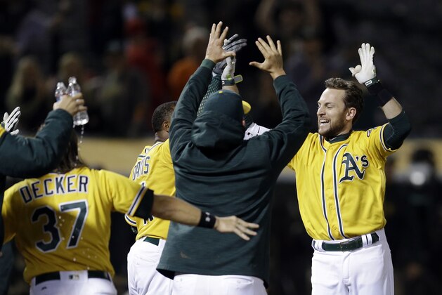 Oakland Athletics' Jed Lowrie, right, celebrates after hitting a walk off home run off Los Angeles Angels' Deolis Guerra in the eleventh inning of a baseball game Monday, May 8, 2017, in Oakland, Calif. (AP Photo/Ben Margot)
