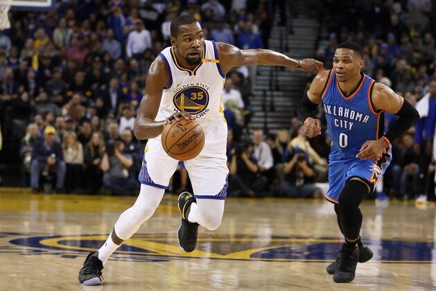 OAKLAND, CA - JANUARY 18:  Kevin Durant #35 of the Golden State Warriors dribbles past Russell Westbrook #0 of the Oklahoma City Thunder at ORACLE Arena on January 18, 2017 in Oakland, California.  NOTE TO USER: User expressly acknowledges and agrees that, by downloading and or using this photograph, User is consenting to the terms and conditions of the Getty Images License Agreement.  (Photo by Ezra Shaw/Getty Images)