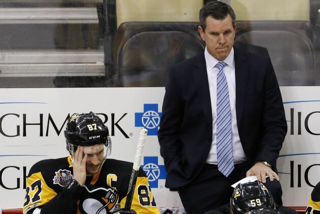 Pittsburgh Penguins' Sidney Crosby (87) sits on the bench with head coach Mike Sullivan behind him during the third period of Game 6 in an NHL Stanley Cup Eastern Conference semifinal hockey game against the Washington Capitals in Pittsburgh, Monday, May 8, 2017. The Capitals won 5-2 to force a Game 7. (AP Photo/Gene J. Puskar)