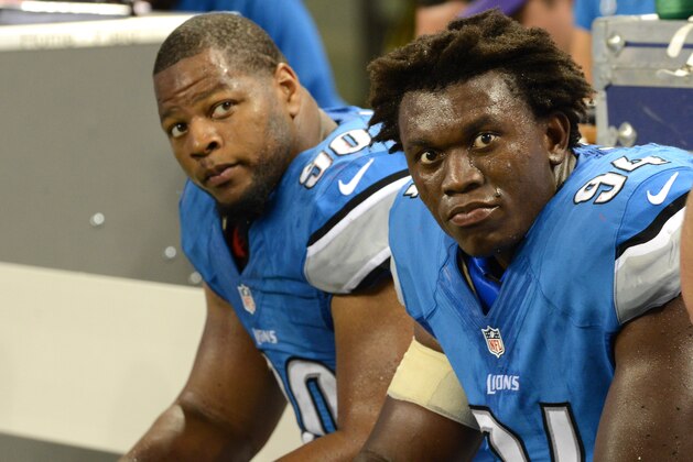 DETROIT, MI - AUGUST 22: Ndamukong Suh #90 and Ezekiel Ansah #94 of the Detroit Lions look on from the sidelines during the game against the New England Patriots at Ford Field on August 22, 2013 in Detroit, Michigan. The Lions defeated the Patriots 40-9. (Photo by Mark Cunningham/Detroit Lions/Getty Images)