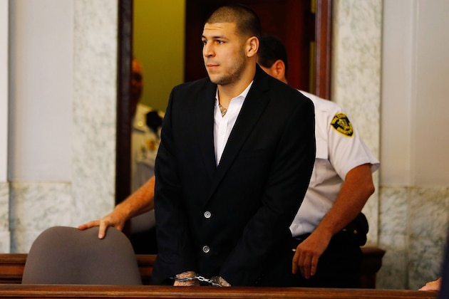 NORTH ATTLEBORO, MA - AUGUST 22: Aaron Hernandez is escorted into the courtroom of the Attleboro District Court for his hearing on August 22, 2013 in North Attleboro, Massachusetts. Former New England Patriot Aaron Hernandez has been indicted on a first-degree murder charge for the death of Odin Lloyd. (Photo by Jared Wickerham/Getty Images)