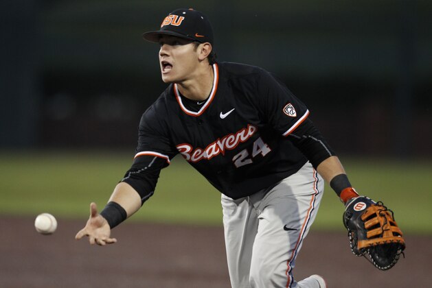 Oregon State's KJ Harrison is too late with the throw to get Dallas Baptist's David Martinelli during an NCAA college baseball tournament regional game Sunday, May 31, 2015, in Dallas. (AP Photo/Ralph Lauer)