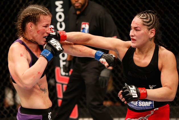 MEXICO CITY, MEXICO - NOVEMBER 15:  (R-L) Jessica Eye punches Leslie Smith in their women's bantamweight fight during the UFC 180 event at the Arena Ciudad de Mexico on November 15, 2014 in Mexico City, Mexico. (Photo by Josh Hedges/Zuffa LLC/Zuffa LLC via Getty Images)