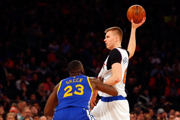 NEW YORK, NY - JANUARY 31:  (NEW YORK DAILIES OUT)    Kristaps Porzingis #6 of the New York Knicks in action against Draymond Green #23 of the Golden State Warriors at Madison Square Garden on January 31, 2016 in New York City. The Warriors defeated the Knicks 116-95.  NOTE TO USER: User expressly acknowledges and agrees that, by downloading and/or using this Photograph, user is consenting to the terms and conditions of the Getty Images License Agreement.  (Photo by Jim McIsaac/Getty Images)