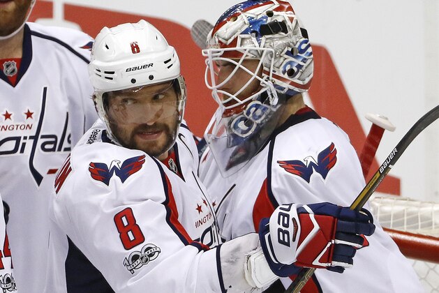 Washington Capitals' Alex Ovechkin (8) celebrates with goalie Braden Holtby after a 5-2 win over the Pittsburgh Penguins in Game 6 of an NHL Stanley Cup Eastern Conference semifinal hockey game in Pittsburgh, Monday, May 8, 2017. (AP Photo/Gene J. Puskar)
