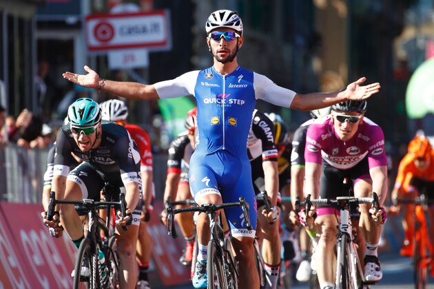 Colombia's Fernando Gaviria of team Quick-Step celebrates as he crosses the finish line of the 5th stage of the 100th Giro d'Italia, Tour of Italy, cycling race from Pedara to Messina on May 10, 2017 in Sicily. 
Gaviria, of the Quick Step team, had taken the race lead by winning Sunday's third stage and achieved his second success in a sprint at the finish of the 159km ride from Pedara to Messina, Sicily. / AFP PHOTO / Luk BENIES        (Photo credit should read LUK BENIES/AFP/Getty Images)