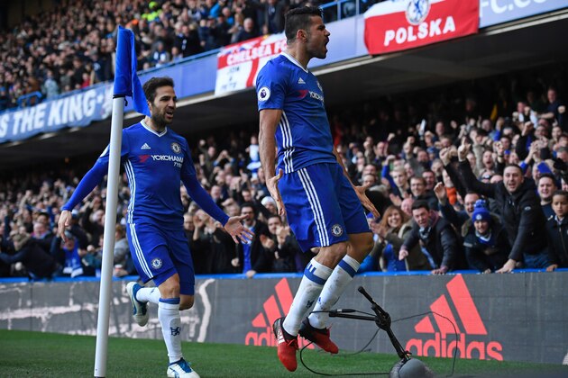 Chelsea's Brazilian-born Spanish striker Diego Costa celebrates with Chelsea's Spanish midfielder Cesc Fabregas (L) after scoring the opening goal of the English Premier League football match between Chelsea and West Bromwich Albion at Stamford Bridge in London on December 11, 2016. / AFP / Justin TALLIS / RESTRICTED TO EDITORIAL USE. No use with unauthorized audio, video, data, fixture lists, club/league logos or 'live' services. Online in-match use limited to 75 images, no video emulation. No use in betting, games or single club/league/player publications.  /         (Photo credit should read JUSTIN TALLIS/AFP/Getty Images)