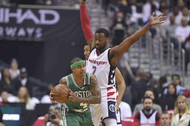 Boston Celtics guard Isaiah Thomas (4) handles the ball against Washington Wizards guard John Wall (2) during the first half in Game 4 of a second-round NBA basketball playoff series, Sunday, May 7, 2017, in Washington. (AP Photo/Nick Wass)