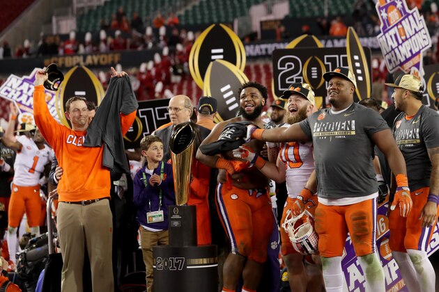 TAMPA, FL - JANUARY 09:  Head coach Dabo Swinney of the Clemson Tigers (L) and defensive tackle Christian Wilkins #42 (C) react after defeating the Alabama Crimson Tide 35-31 to win the 2017 College Football Playoff National Championship Game at Raymond James Stadium on January 9, 2017 in Tampa, Florida.  (Photo by Streeter Lecka/Getty Images)