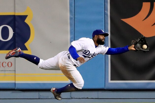 LOS ANGELES, CA - MAY 03:  Andrew Toles #60 of the Los Angeles Dodgers makes a running catch for an out of Hunter Pence #8 of the San Francisco Giants during the 11th inning at Dodger Stadium on May 3, 2017 in Los Angeles, California.  (Photo by Harry How/Getty Images)