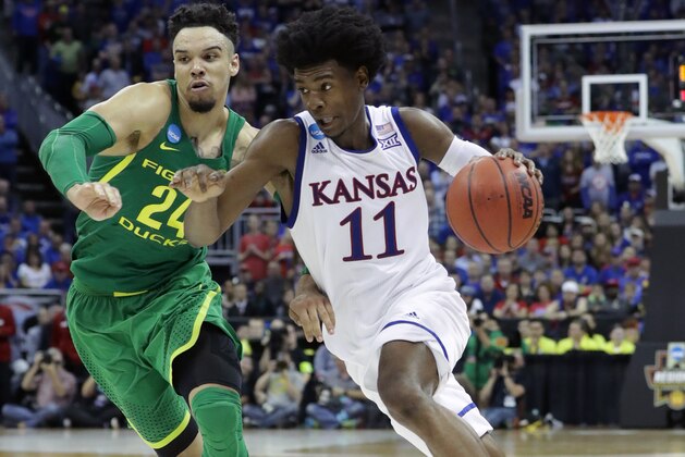 KANSAS CITY, MO - MARCH 25: Josh Jackson #11 of the Kansas Jayhawks is defended by Dillon Brooks #24 of the Oregon Ducks during the 2017 NCAA Men's Basketball Tournament Midwest Regional at Sprint Center on March 25, 2017 in Kansas City, Missouri.  (Photo by Ronald Martinez/Getty Images)