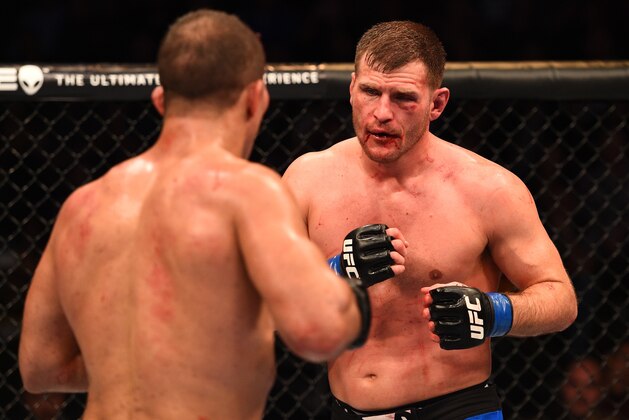 PHOENIX, AZ - DECEMBER 13:  (R-L) Stipe Miocic battles Junior Dos Santos of Brazil in their heavyweight fight during the UFC Fight Night event at the U.S. Airways Center on December 13, 2014 in Phoenix, Arizona.  (Photo by Josh Hedges/Zuffa LLC/Zuffa LLC via Getty Images)