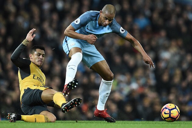Arsenal's Chilean striker Alexis Sanchez (L) vies with Manchester City's Brazilian midfielder Fernando during the English Premier League football match between Manchester City and Arsenal at the Etihad Stadium in Manchester, north west England, on December 18, 2016. / AFP / Oli SCARFF / RESTRICTED TO EDITORIAL USE. No use with unauthorized audio, video, data, fixture lists, club/league logos or 'live' services. Online in-match use limited to 75 images, no video emulation. No use in betting, games or single club/league/player publications.  /         (Photo credit should read OLI SCARFF/AFP/Getty Images)